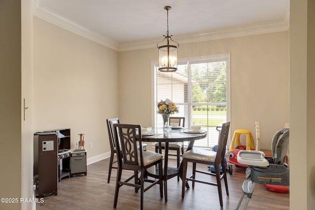 742 Hummingbird Ln, New Iberia, LA 70563 - dining space featuring dark wood-style flooring, a chandelier, and ornamental molding
