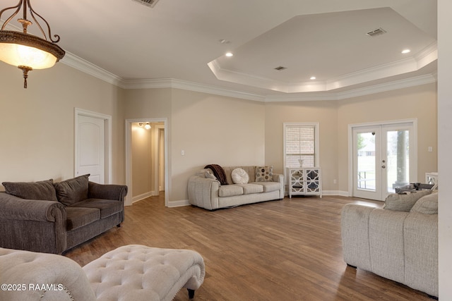 742 Hummingbird Ln, New Iberia, LA 70563 - living room with wood finished floors, crown molding, a raised ceiling, french doors, and recessed lighting