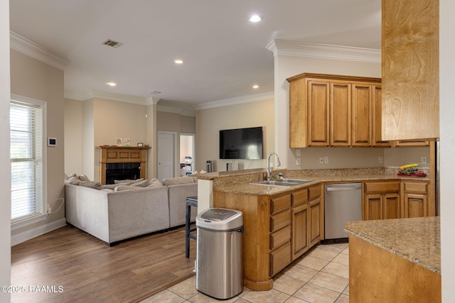 742 Hummingbird Ln, New Iberia, LA 70563 - kitchen with stainless steel dishwasher, open floor plan, a peninsula, a fireplace, and ornamental molding