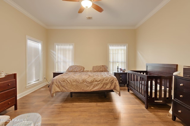 742 Hummingbird Ln, New Iberia, LA 70563 - bedroom with ornamental molding, light wood-style floors, and a ceiling fan