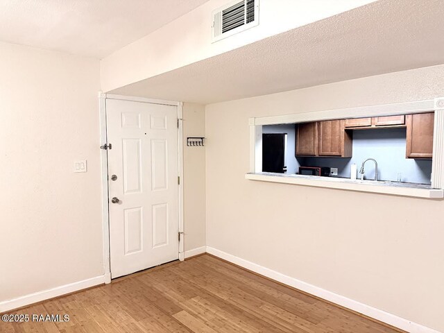 3121 Johnston St Unit 207, Lafayette, LA 70503 - kitchen featuring light wood finished floors and light countertops
