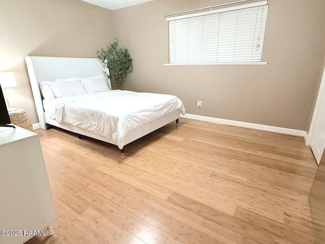 3121 Johnston St Unit 207, Lafayette, LA 70503 - bedroom featuring wood finished floors and baseboards