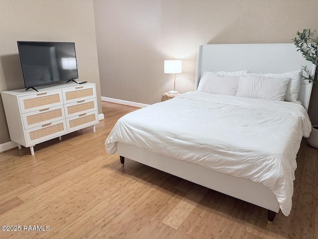 3121 Johnston St Unit 207, Lafayette, LA 70503 - bedroom featuring light wood finished floors and baseboards