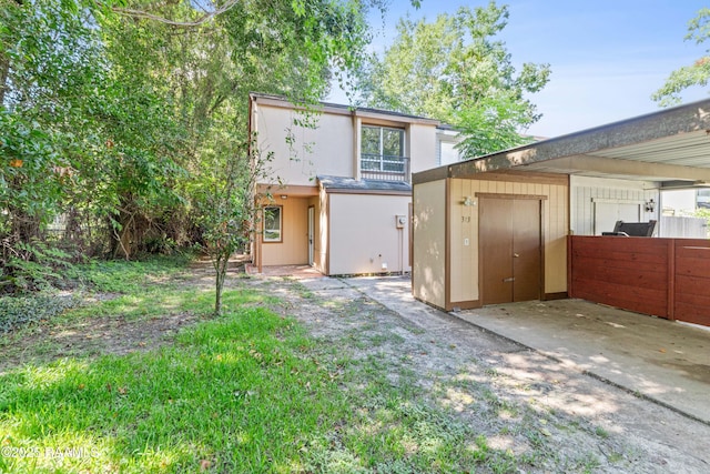 313 Sidney Martin Rd, Lafayette, LA 70507 - rear view of house with a storage shed and stucco siding