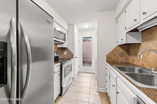 313 Sidney Martin Rd, Lafayette, LA 70507 - kitchen with appliances with stainless steel finishes, white cabinetry, dark countertops, backsplash, and light tile patterned flooring