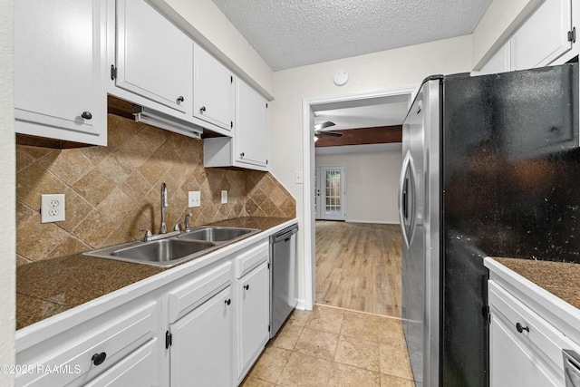 313 Sidney Martin Rd, Lafayette, LA 70507 - kitchen featuring stainless steel appliances, a ceiling fan, white cabinets, tile countertops, and decorative backsplash