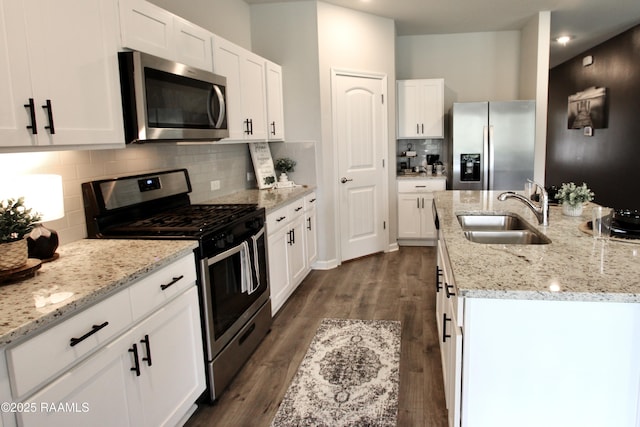 205 Acadian Lake Dr, Duson, LA 70529 - kitchen featuring stainless steel appliances, white cabinets, and a kitchen island with sink