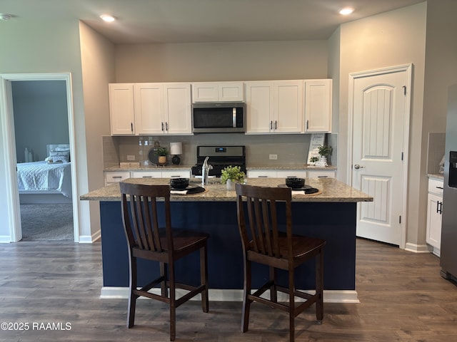 205 Acadian Lake Dr, Duson, LA 70529 - kitchen featuring appliances with stainless steel finishes, backsplash, white cabinets, and recessed lighting