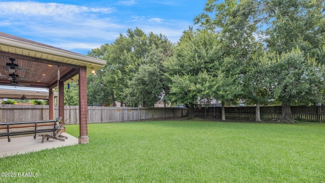 201 Spanish Moss Ln, Broussard, LA 70518 - fenced backyard with ceiling fan and a patio area