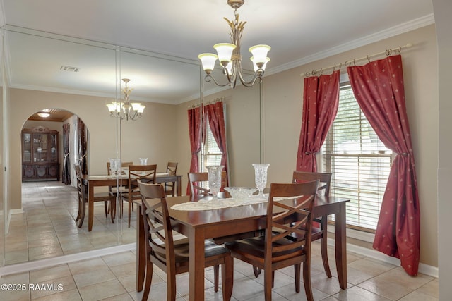 122 Thrush Loop, Lafayette, LA 70508 - dining area with a chandelier, arched walkways, ornamental molding, and light tile patterned flooring