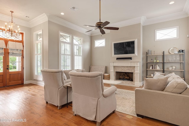 301 Gleneagles Cir, Broussard, LA 70518 - living room with light wood-type flooring, a chandelier, ceiling fan, a premium fireplace, and crown molding