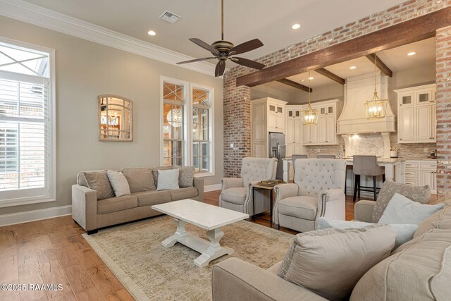 301 Gleneagles Cir, Broussard, LA 70518 - living room with healthy amount of natural light, light wood finished floors, ceiling fan, recessed lighting, and beam ceiling