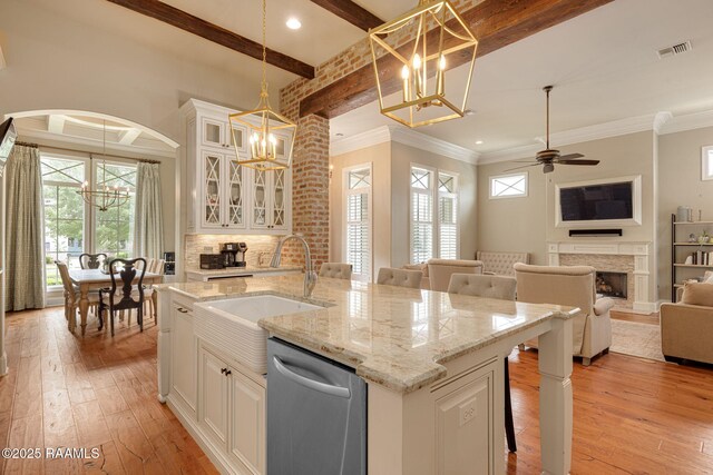 301 Gleneagles Cir, Broussard, LA 70518 - kitchen with dishwasher, a chandelier, light wood-style floors, a fireplace, and beam ceiling