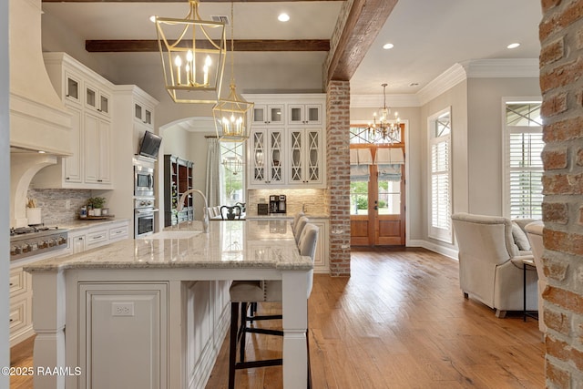 301 Gleneagles Cir, Broussard, LA 70518 - kitchen featuring a chandelier, stainless steel appliances, premium range hood, plenty of natural light, and beam ceiling