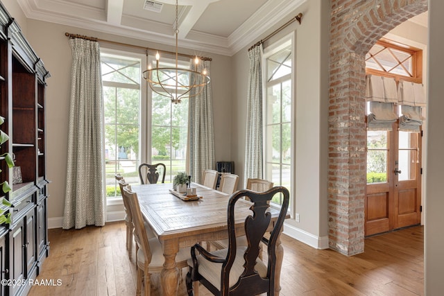 301 Gleneagles Cir, Broussard, LA 70518 - dining room with a chandelier, healthy amount of natural light, light wood-style flooring, ornamental molding, and coffered ceiling