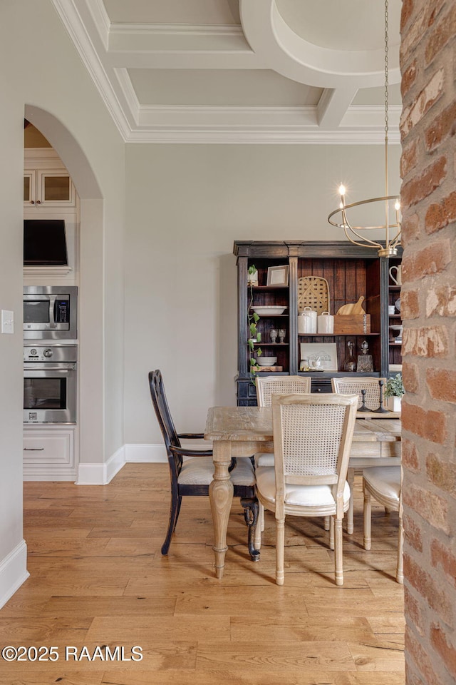 301 Gleneagles Cir, Broussard, LA 70518 - dining room featuring crown molding, a chandelier, light wood-style floors, arched walkways, and coffered ceiling