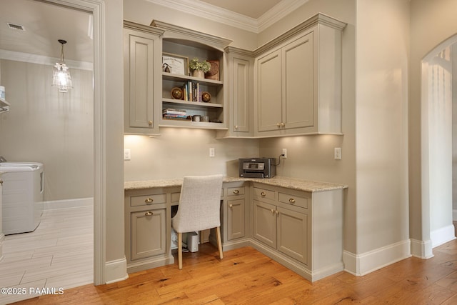 301 Gleneagles Cir, Broussard, LA 70518 - office area with washer and dryer, light wood-style floors, built in desk, ornamental molding, and arched walkways