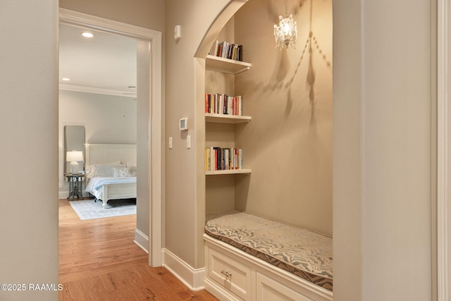 301 Gleneagles Cir, Broussard, LA 70518 - corridor with light wood-type flooring, ornamental molding, built in features, and arched walkways
