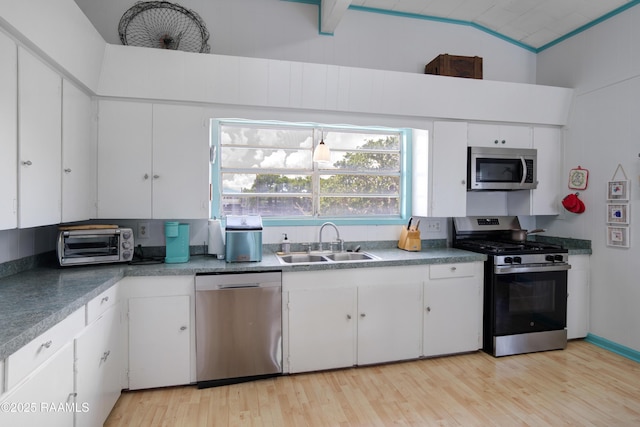 116 Sunset Blvd, Cypremort Point, LA 70538 - kitchen featuring appliances with stainless steel finishes, light wood-type flooring, white cabinetry, and vaulted ceiling