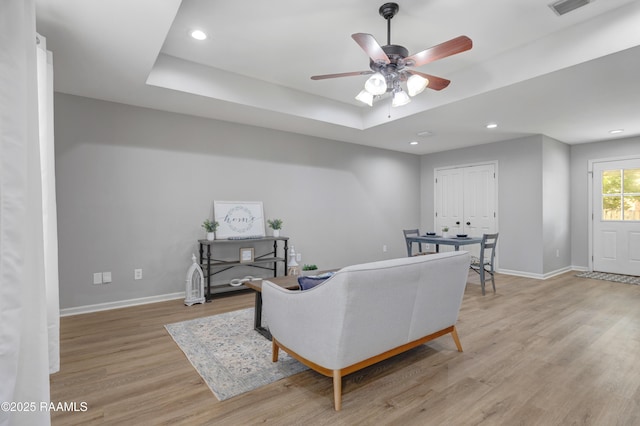 1404 Howard St, New Iberia, LA 70563 - living room with a tray ceiling, light wood finished floors, a ceiling fan, and recessed lighting