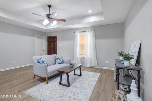 1404 Howard St, New Iberia, LA 70563 - living room featuring a tray ceiling, a ceiling fan, light wood-type flooring, and recessed lighting