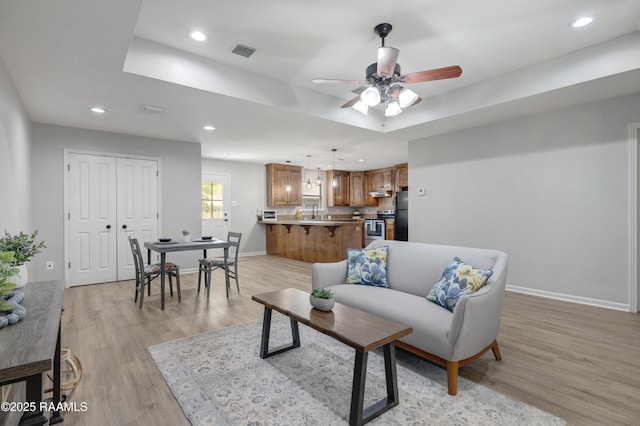 1404 Howard St, New Iberia, LA 70563 - living area with light wood-type flooring, ceiling fan, and recessed lighting