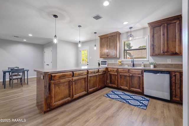 1404 Howard St, New Iberia, LA 70563 - kitchen with stainless steel dishwasher, a peninsula, light wood-style flooring, pendant lighting, and recessed lighting