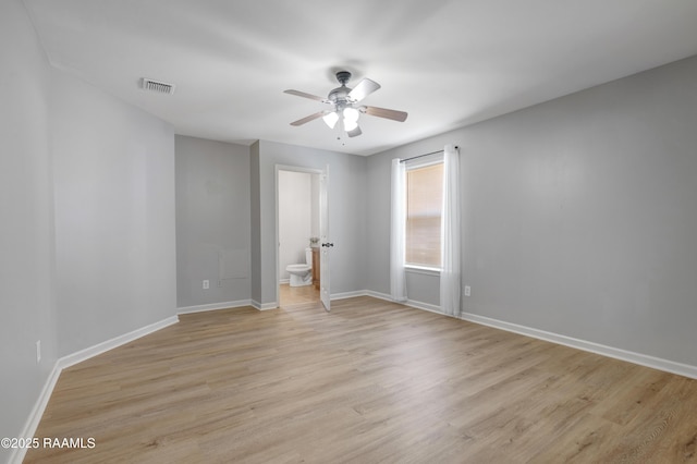 1404 Howard St, New Iberia, LA 70563 - unfurnished bedroom with light wood-style floors, connected bathroom, and ceiling fan