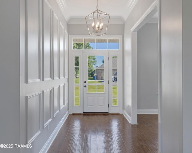 12511 Aube Dr, Abbeville, LA 70510 - entrance foyer with a chandelier, dark wood-style floors, and ornamental molding