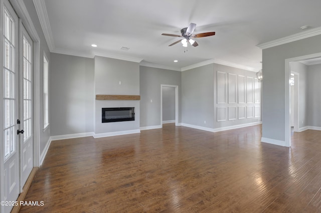 12511 Aube Dr, Abbeville, LA 70510 - unfurnished living room featuring healthy amount of natural light, a ceiling fan, a glass covered fireplace, dark wood-style flooring, and recessed lighting