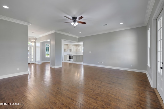 12511 Aube Dr, Abbeville, LA 70510 - unfurnished living room featuring ceiling fan, a chandelier, dark wood-type flooring, ornamental molding, and recessed lighting