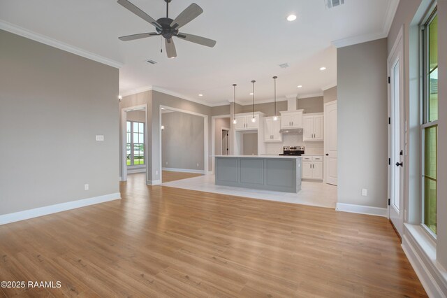 11511 Baker Senior Dr, Abbeville, LA 70510 - unfurnished living room with recessed lighting, crown molding, light wood-type flooring, and ceiling fan