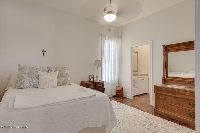 7804 Picard Rd, Maurice, LA 70555 - bedroom with ensuite bath, a ceiling fan, and dark wood-style flooring