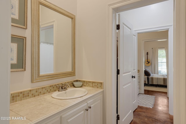 7804 Picard Rd, Maurice, LA 70555 - full bath featuring vanity, wood finished floors, connected bathroom, and backsplash