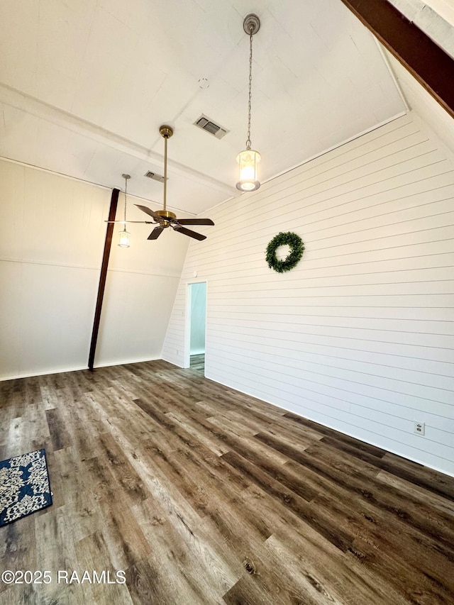 607 Ernest St, New Iberia, LA 70563 - unfurnished living room featuring wood finished floors, a ceiling fan, and wood walls