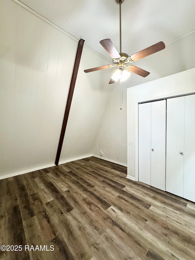 607 Ernest St, New Iberia, LA 70563 - unfurnished bedroom featuring dark wood-style flooring, lofted ceiling, ceiling fan, and a closet