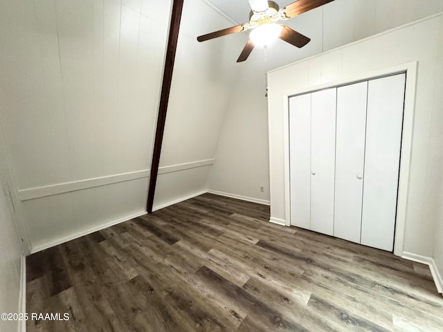 607 Ernest St, New Iberia, LA 70563 - unfurnished bedroom featuring wood finished floors, a closet, vaulted ceiling, and a ceiling fan