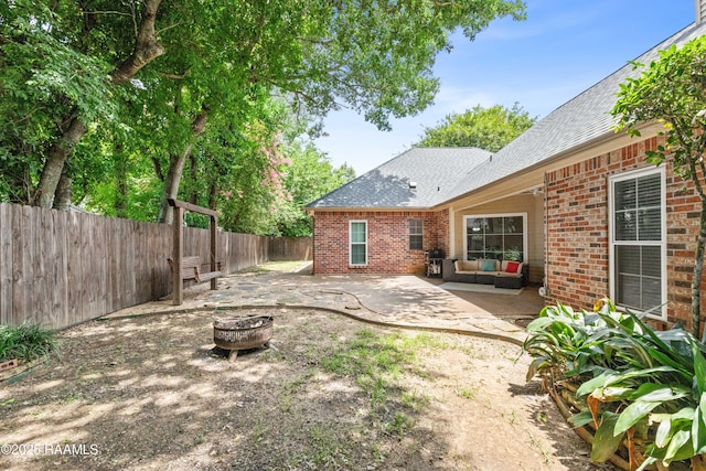 117 Montero Cir, Lafayette, LA 70503 - fenced backyard with a patio area and an outdoor living space with a fire pit