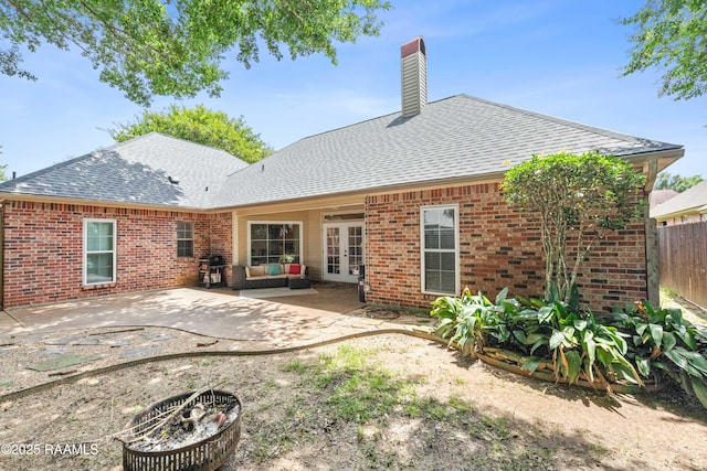 117 Montero Cir, Lafayette, LA 70503 - back of property with french doors, a shingled roof, brick siding, a chimney, and a patio area