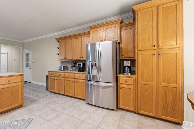 117 Montero Cir, Lafayette, LA 70503 - kitchen with stainless steel fridge, ornamental molding, light countertops, light tile patterned flooring, and tasteful backsplash