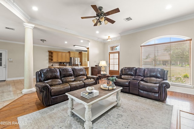 117 Montero Cir, Lafayette, LA 70503 - living area with ornate columns, ceiling fan, healthy amount of natural light, light wood-style flooring, and crown molding