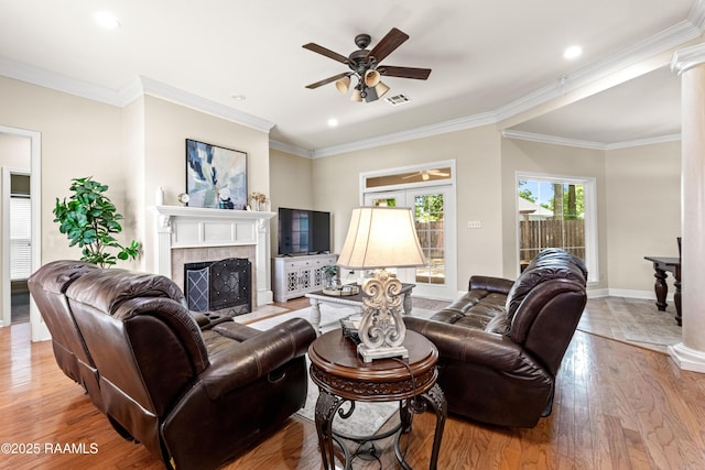 117 Montero Cir, Lafayette, LA 70503 - living area with a ceiling fan, a tile fireplace, wood finished floors, ornamental molding, and ornate columns