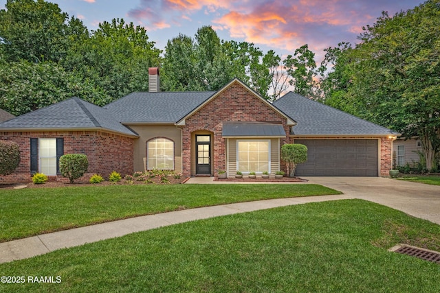 117 Montero Cir, Lafayette, LA 70503 - view of front of home with driveway, an attached garage, roof with shingles, a yard, and a chimney