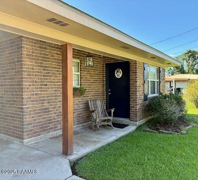 105 Sugar Dr, Broussard, LA 70518 - doorway to property featuring brick siding