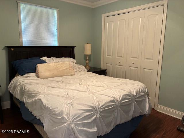 105 Sugar Dr, Broussard, LA 70518 - bedroom featuring a closet, crown molding, and dark wood-style flooring