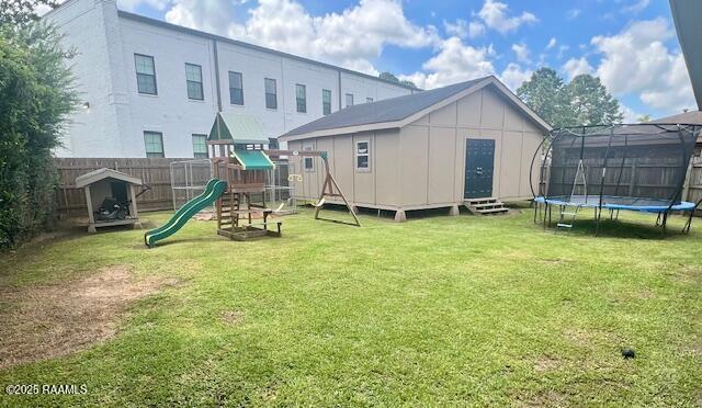 105 Sugar Dr, Broussard, LA 70518 - back of house with a trampoline, board and batten siding, a playground, a fenced backyard, and a storage shed