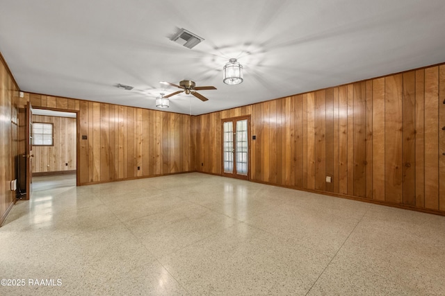1212 S Main St, Breaux Bridge, LA 70517 - empty room featuring a ceiling fan, wood walls, healthy amount of natural light, and light floors