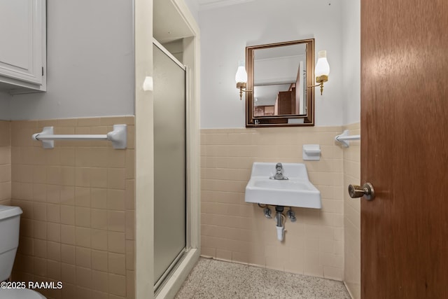1212 S Main St, Breaux Bridge, LA 70517 - full bath featuring tile walls, speckled floor, a wainscoted wall, and a shower stall