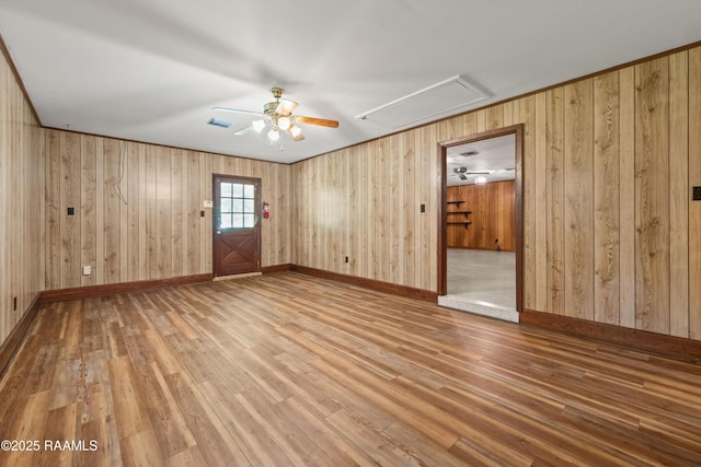 1212 S Main St, Breaux Bridge, LA 70517 - spare room featuring attic access, a ceiling fan, wood finished floors, and wood walls