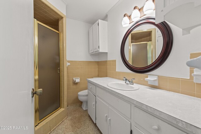 1212 S Main St, Breaux Bridge, LA 70517 - full bathroom with speckled floor, vanity, a shower stall, a wainscoted wall, and tile walls